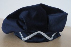 niebieski kapelusz z diamentową ozdobą.